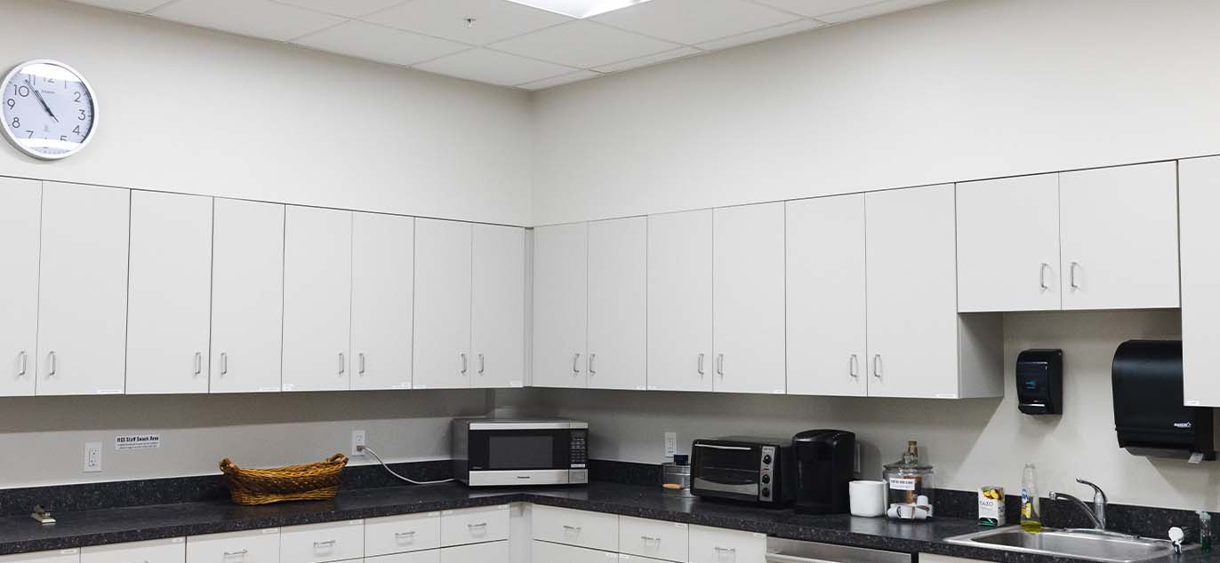 Kitchen area with white cabinets