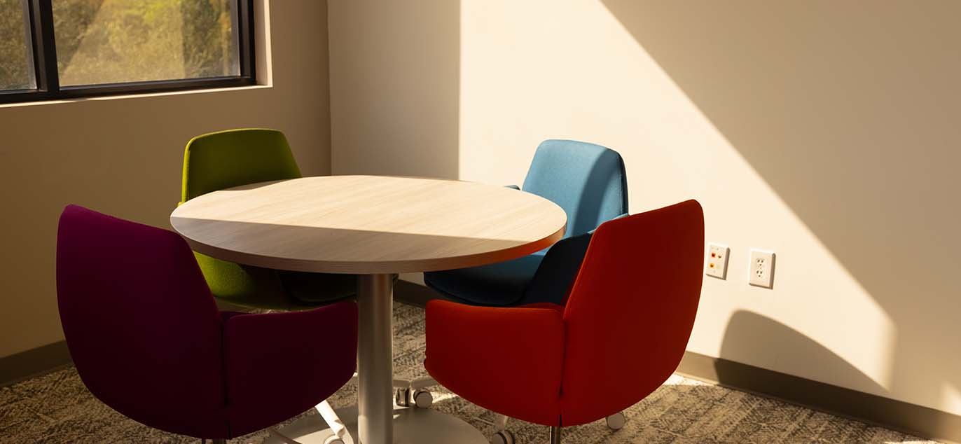 Round table with colorful chairs